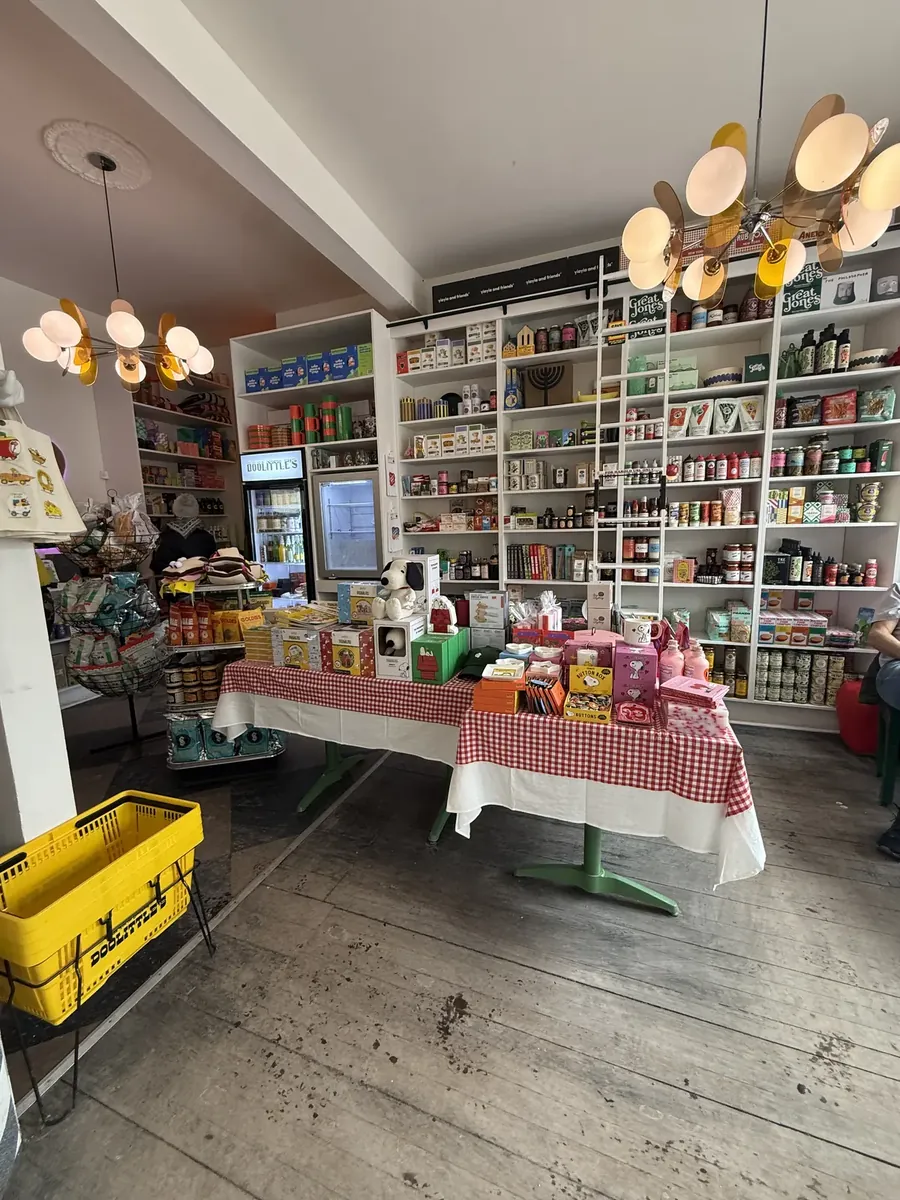 Shelves of groceries and a table with a red gingham cloth inside Doolittle's general store and cafe on Main Street in Fleischmanns, NY